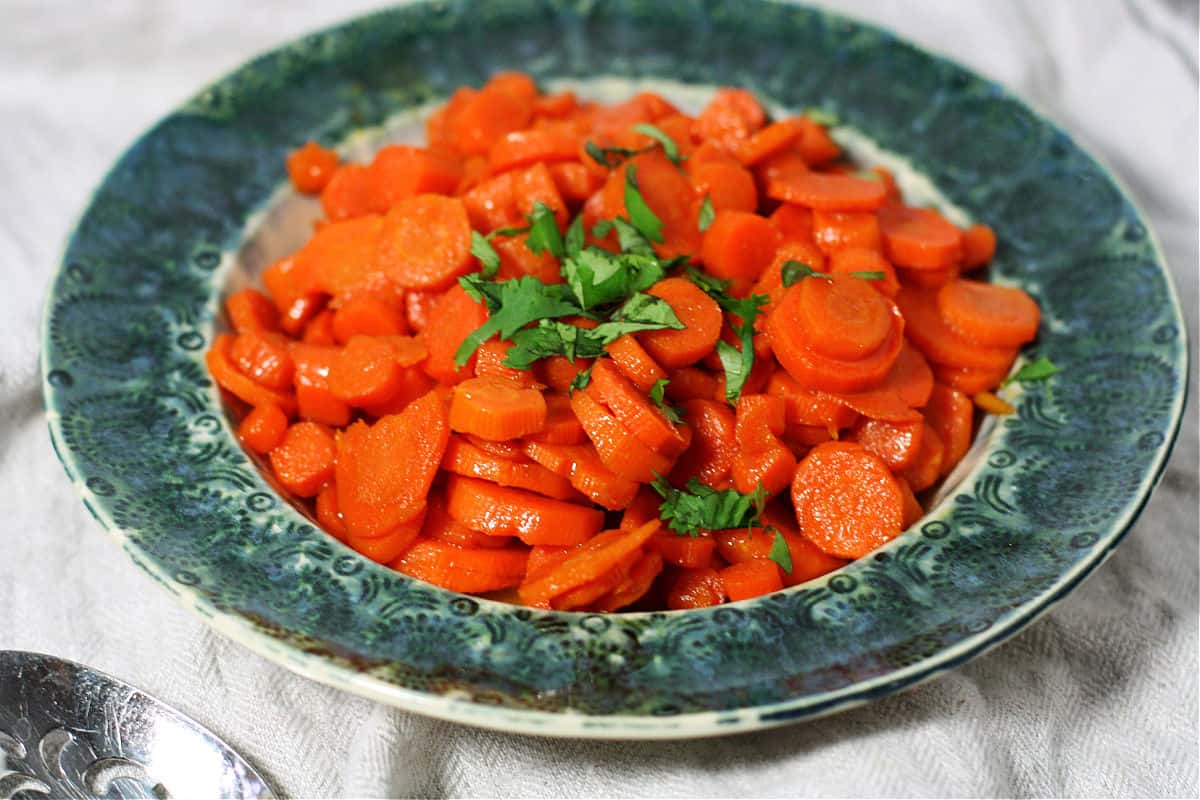 carrots glazed with brown sugar in a teal dish