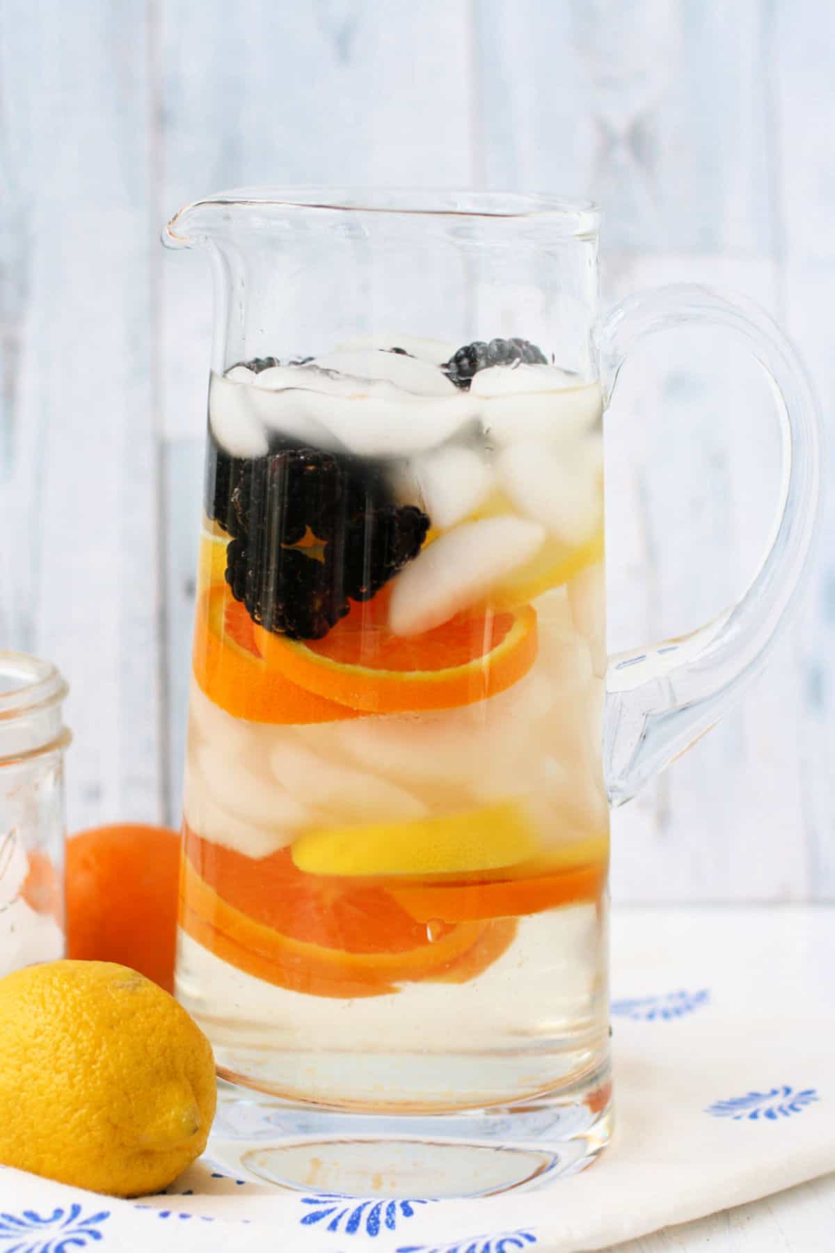 citrus infused water in a clear pitcher