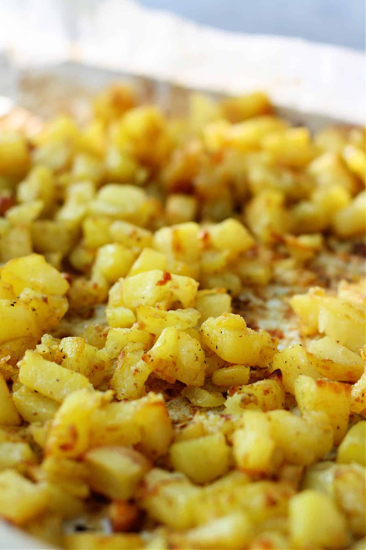 vegan cheesy garlic roasted potatoes on a baking sheet