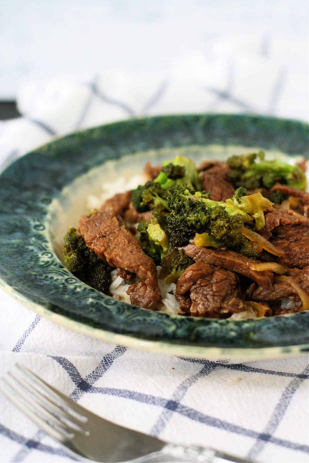 dairy free broccoli beef stirfry in a blue and white bowl