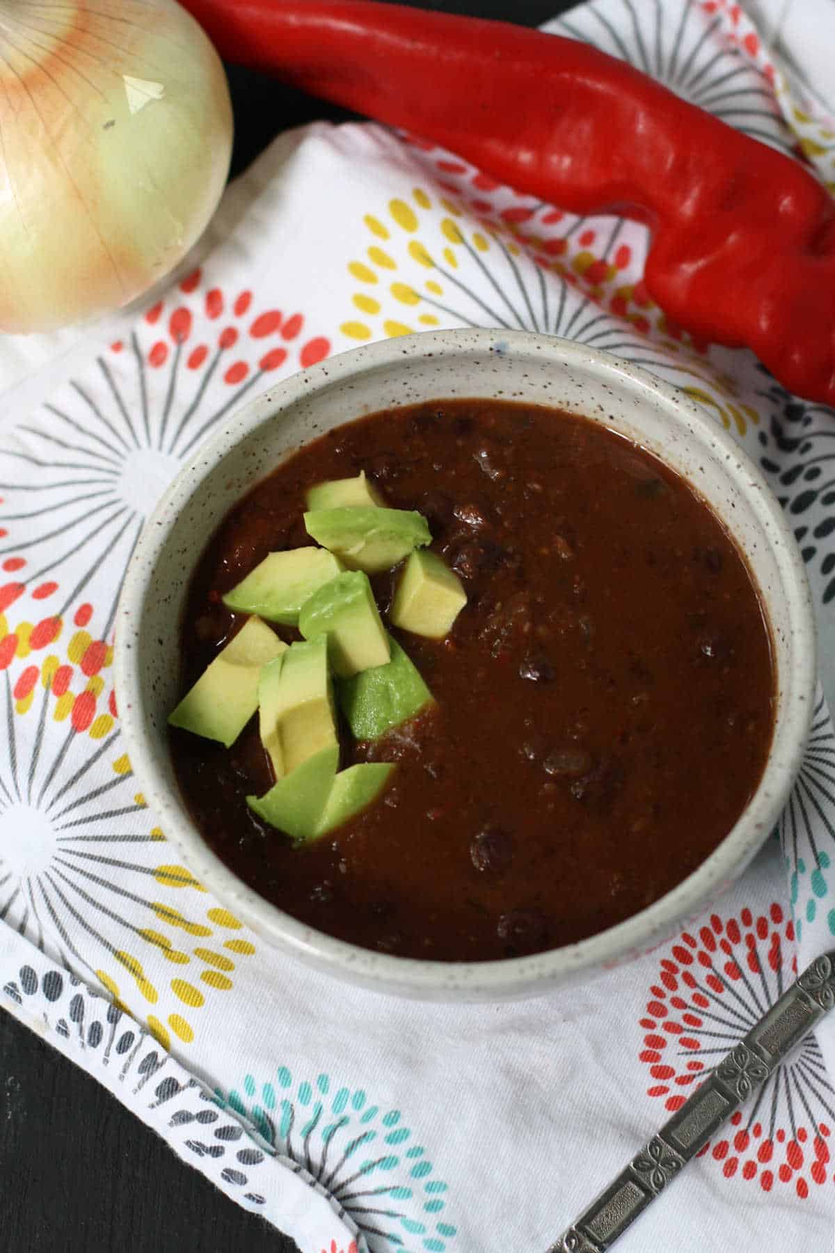 slow cooker vegan black bean soup in a stoneware bowl
