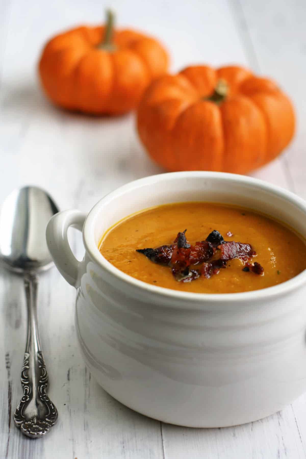 dairy free squash and apple soup in a white bowl