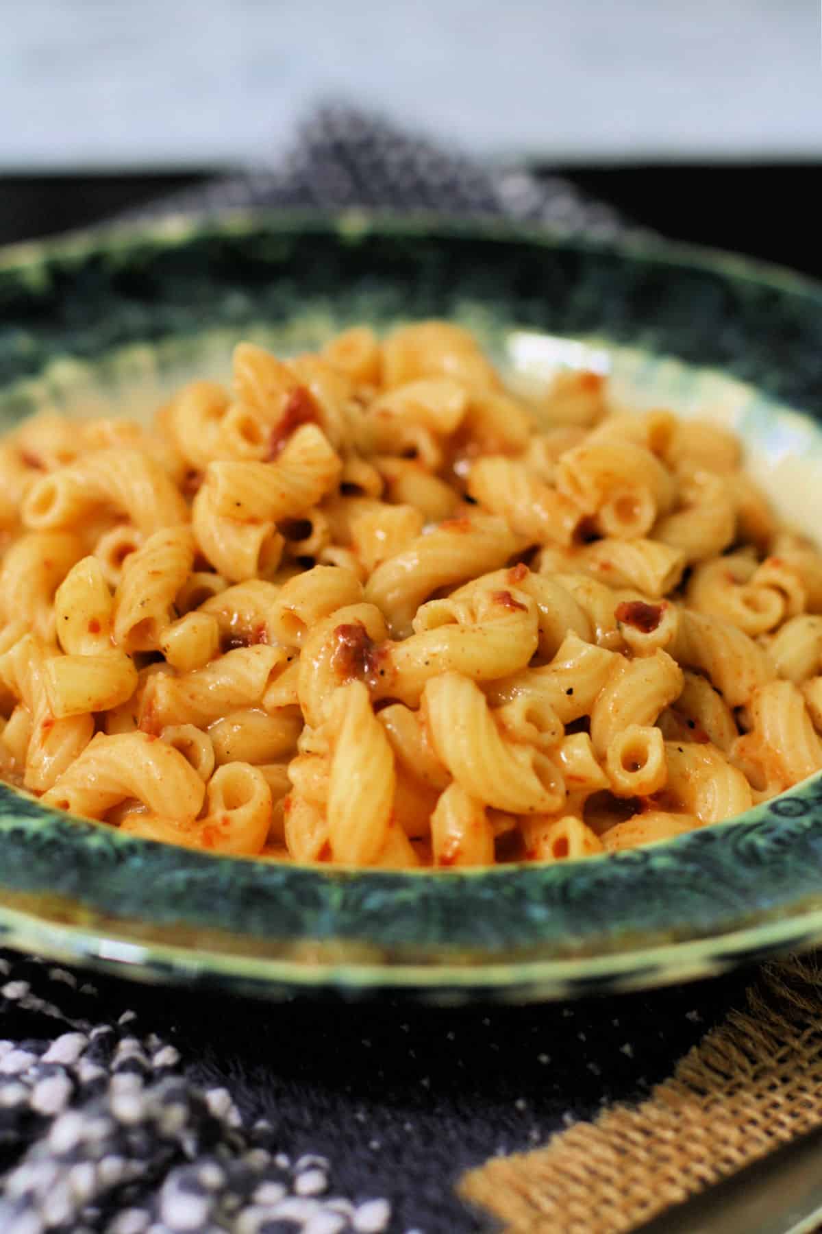 dairy free sun dried tomato pasta in a teal bowl