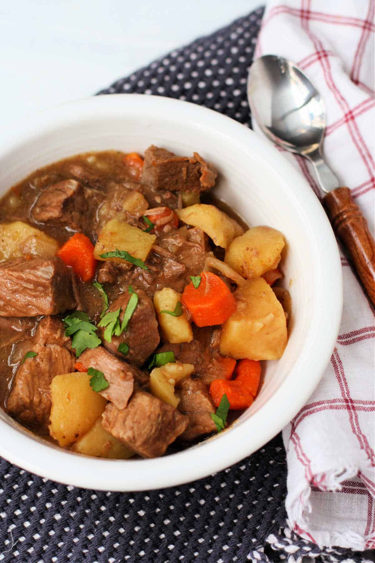 easy slow cooker beef stew with veggies in a white bowl