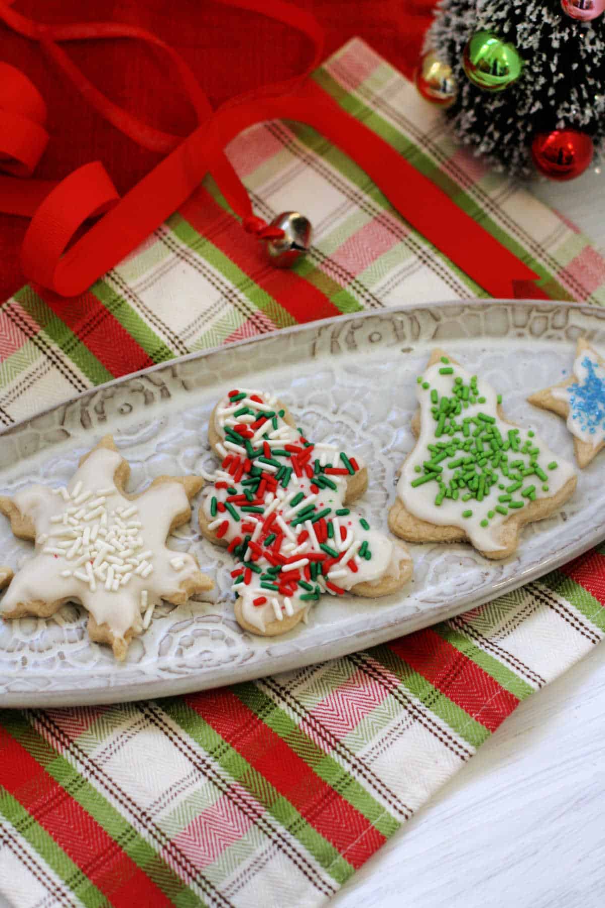 gluten free vegan frosted sugar cookies on a white tray