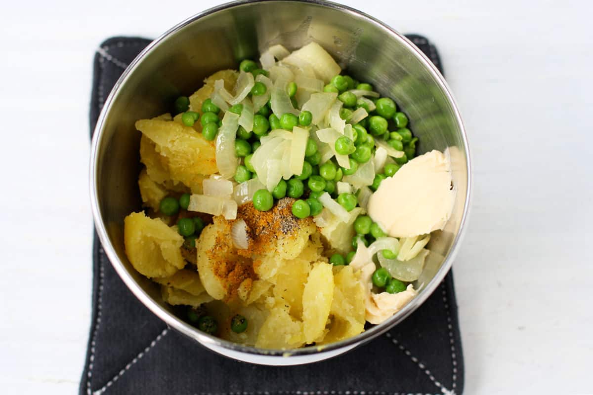 potatoes peas and onions in a bowl