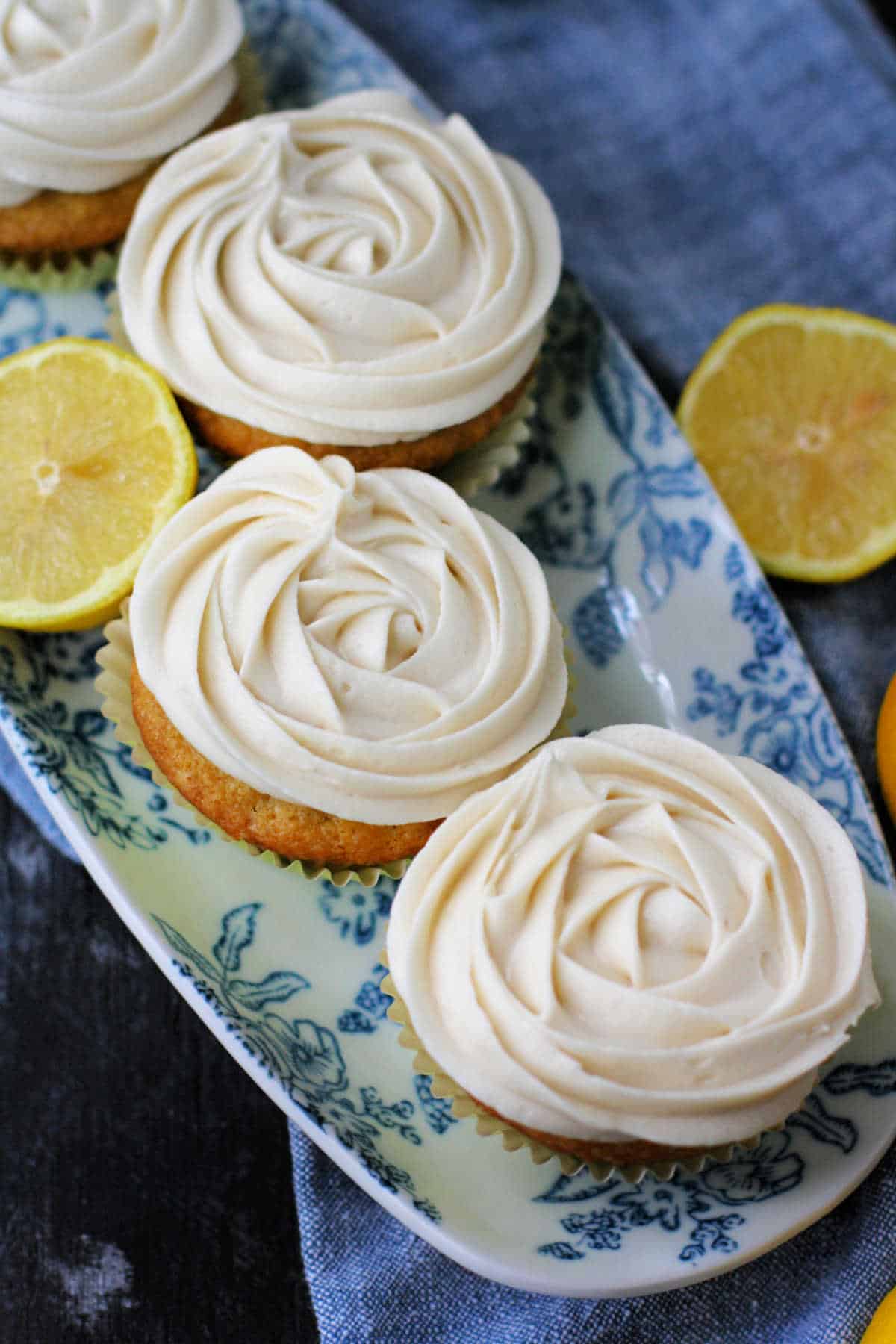 vegan lemon cupcakes with icing on a tray
