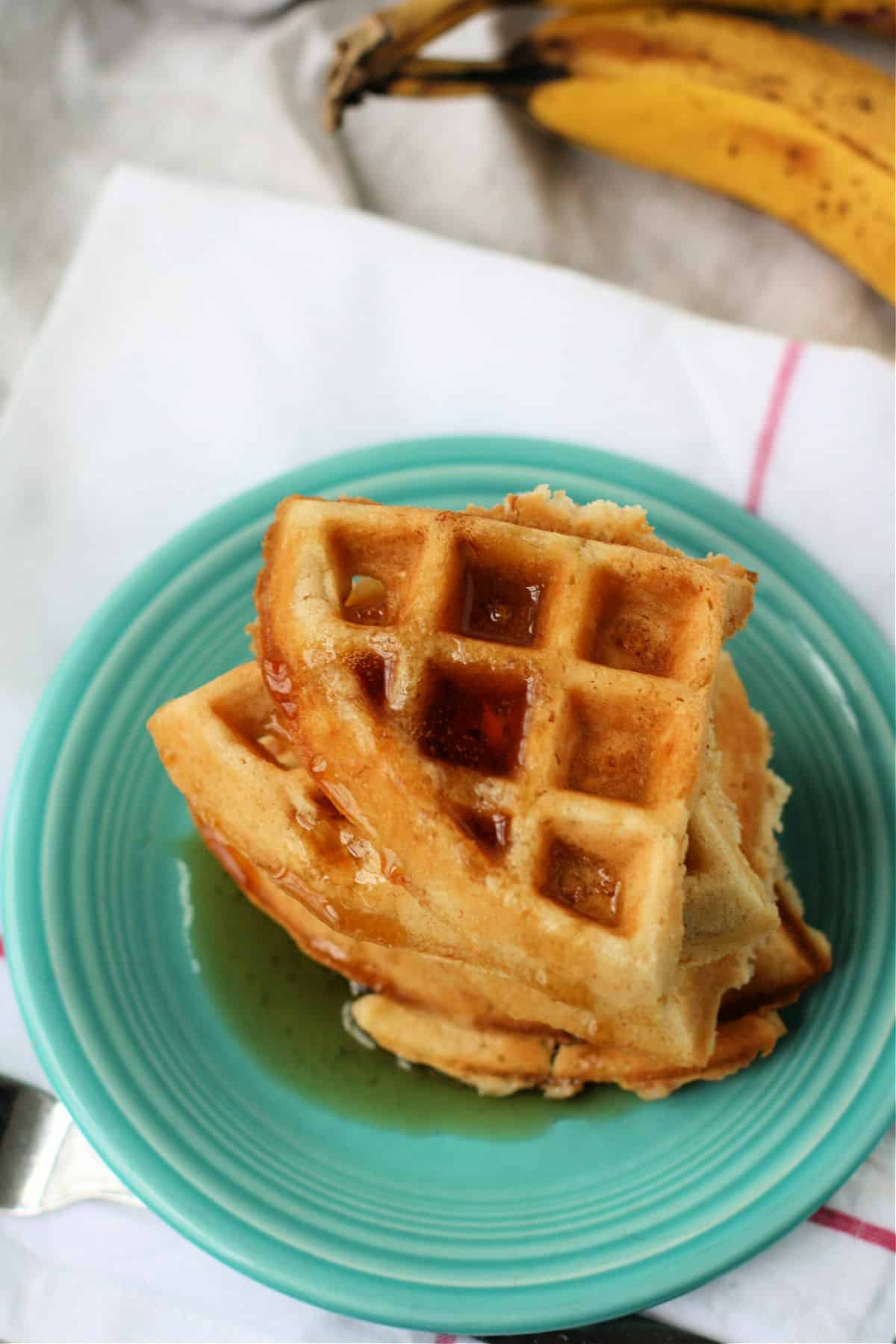 fluffy vegan banana waffles with maple syrup