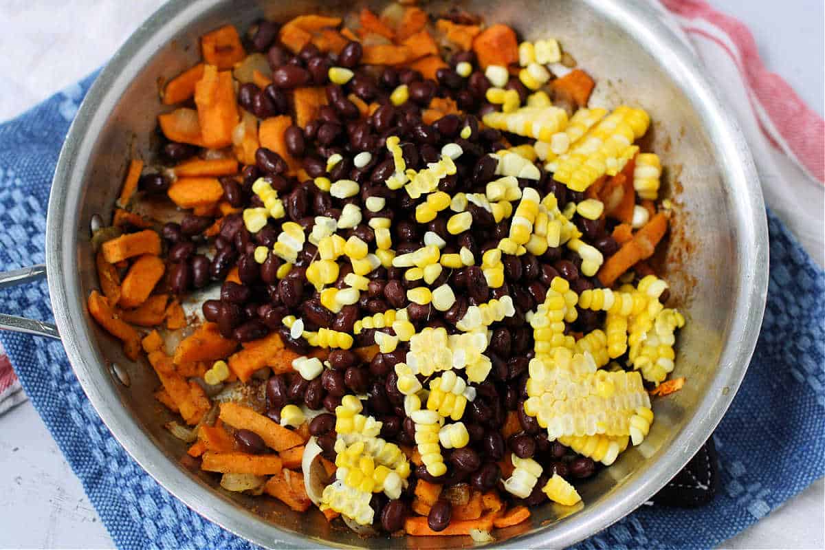 adding beans and corn to skillet