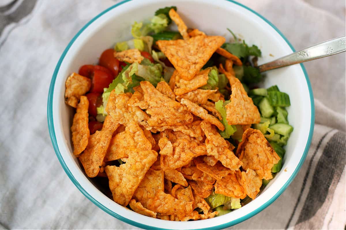 adding chips to taco salad