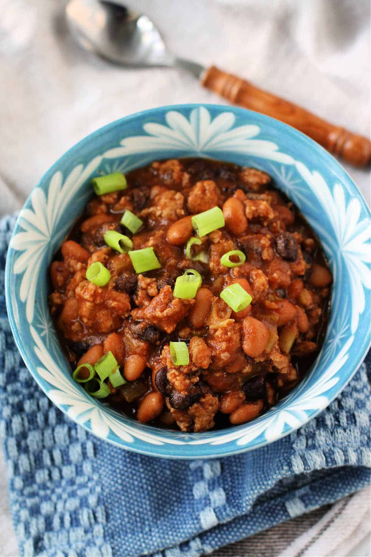 baked bean turkey chili in a blue and white bowl