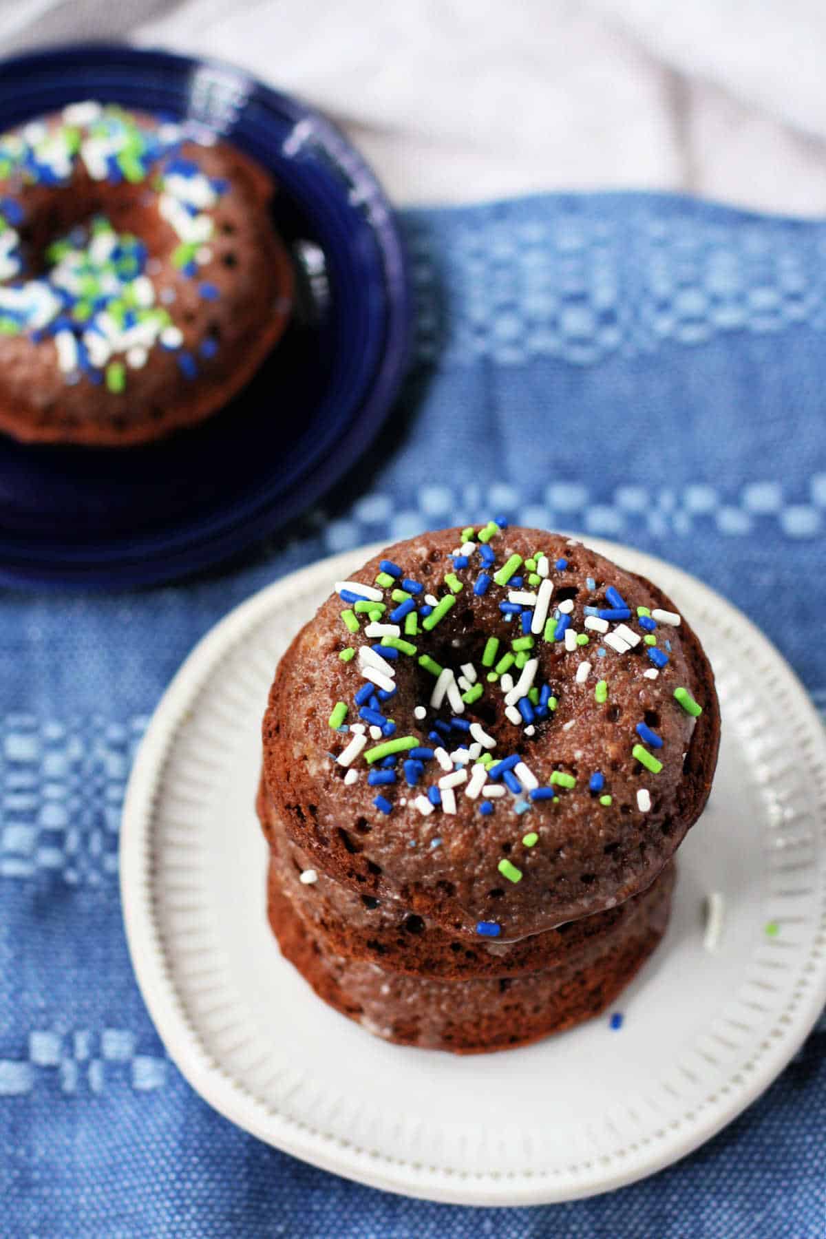 dairy free chocolate donuts with sprinkles on a plate