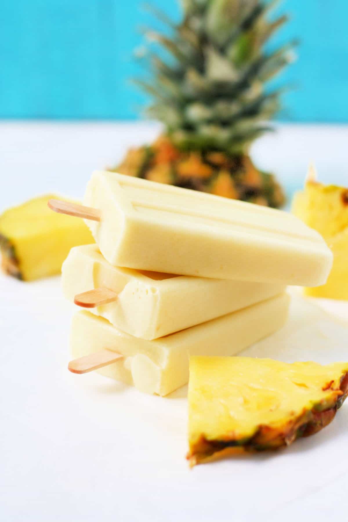 dairy free pina colada popsicles stacked up