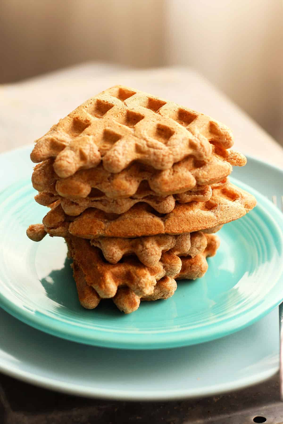 maple vanilla waffles stacked on a plate