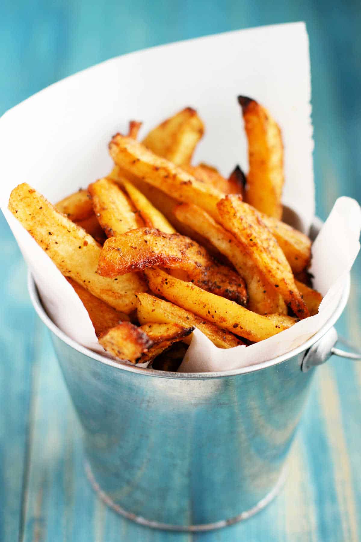 oven roasted french fries in a silver bucket