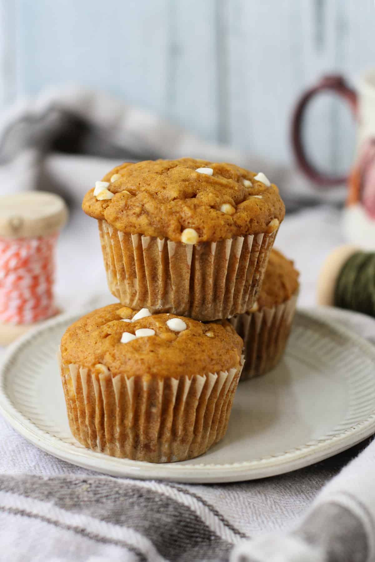 pumpkin muffins stacked on a plate