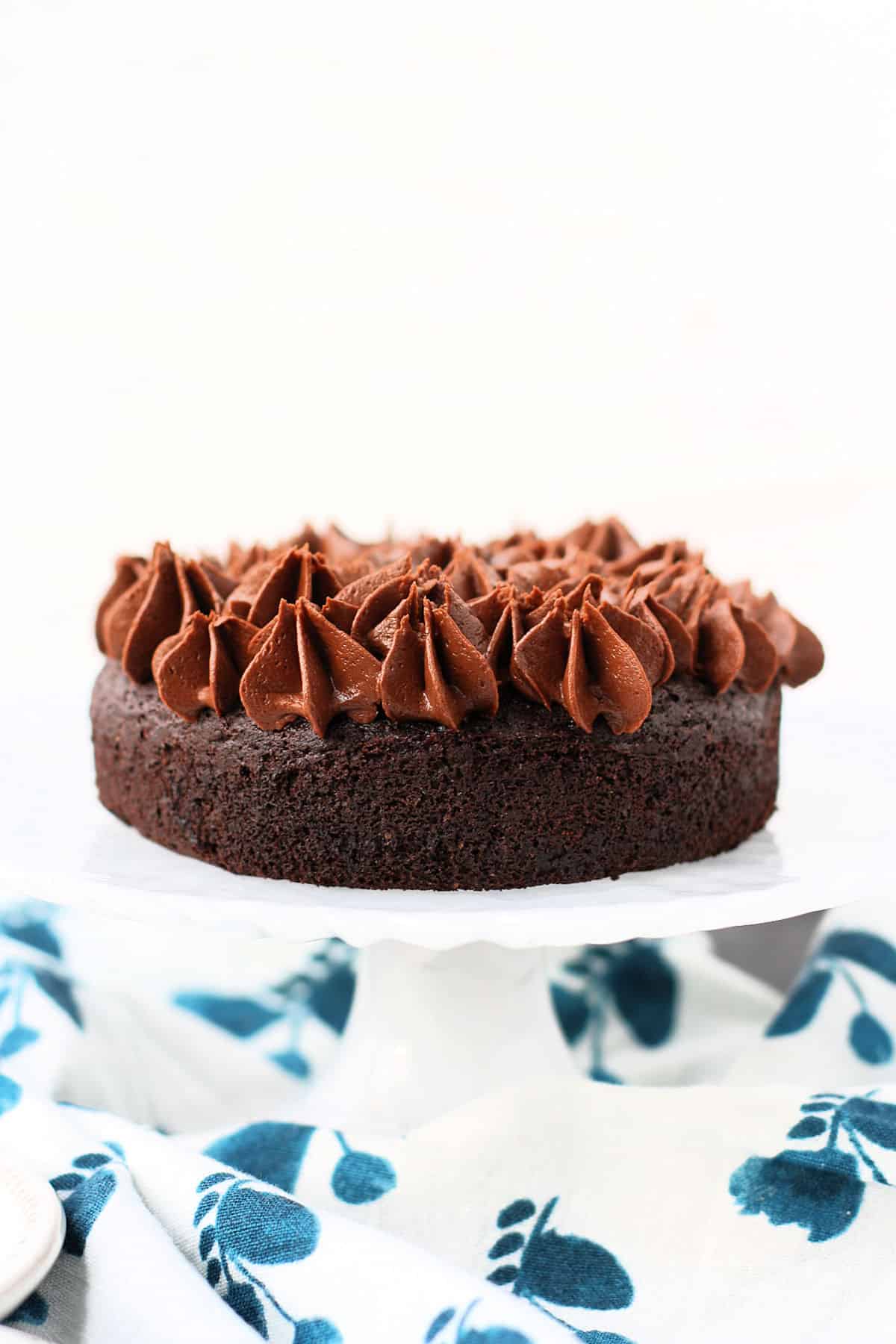 small gluten free chocolate cake on a small cake stand