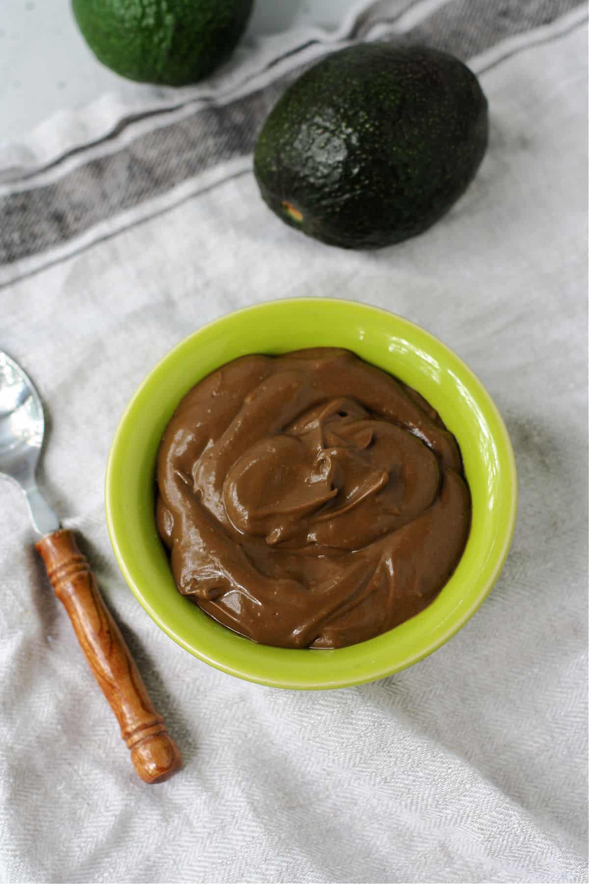 vegan chocolate avocado pudding in a green bowl