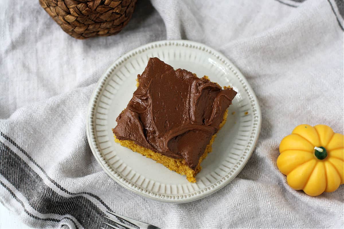 slice of pumpkin cake with chocolate frosting
