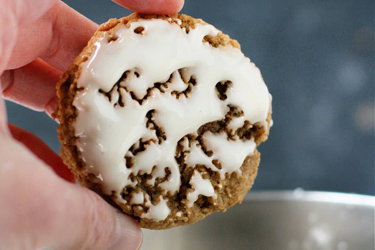 dipping oatmeal cookies into glaze