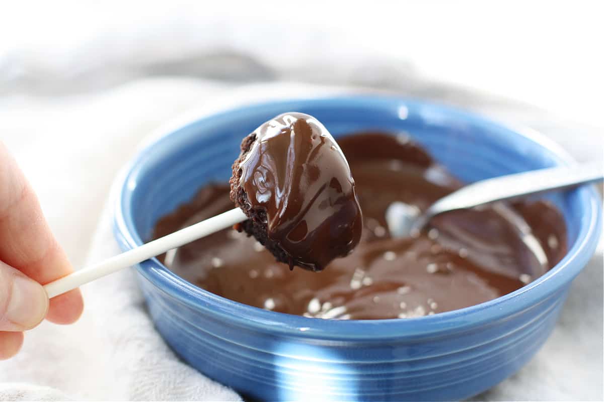 dipping cake balls in melted chocolate