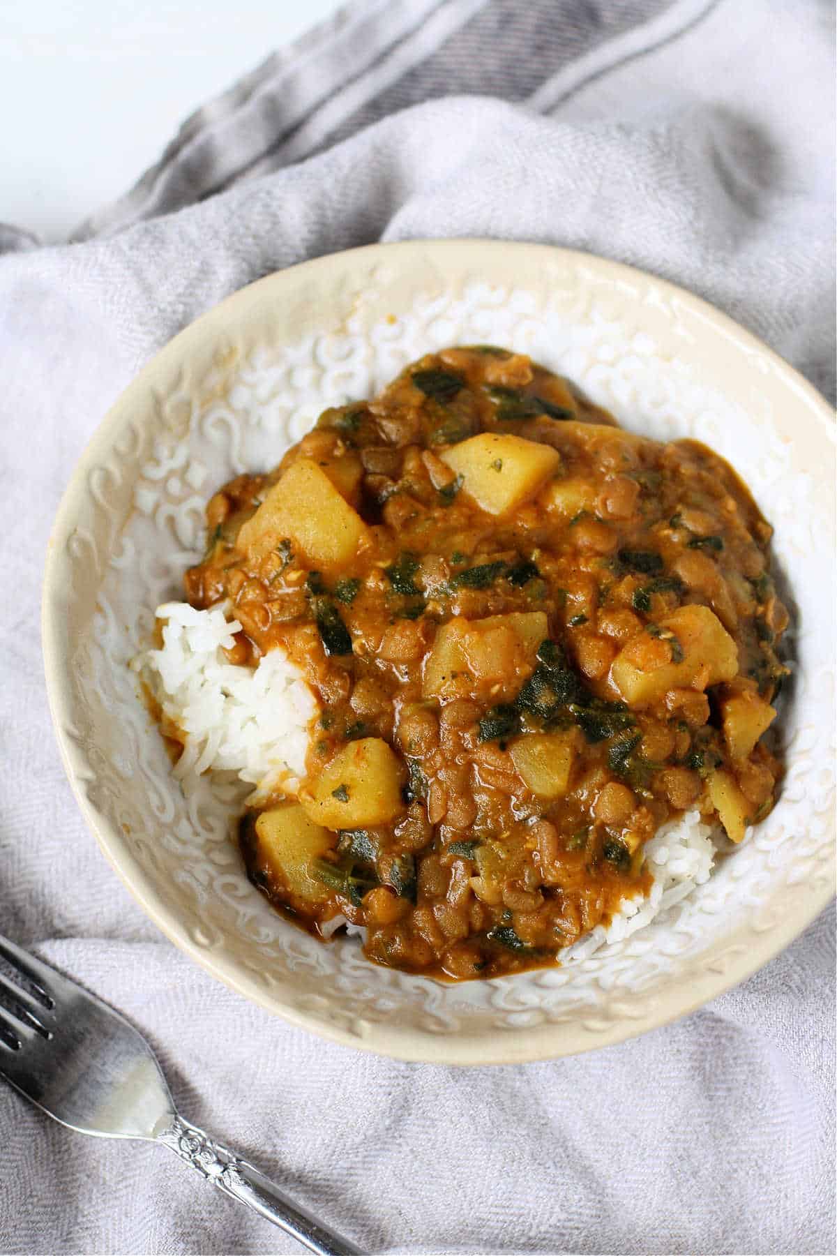 lentil potato curry in a white bowl