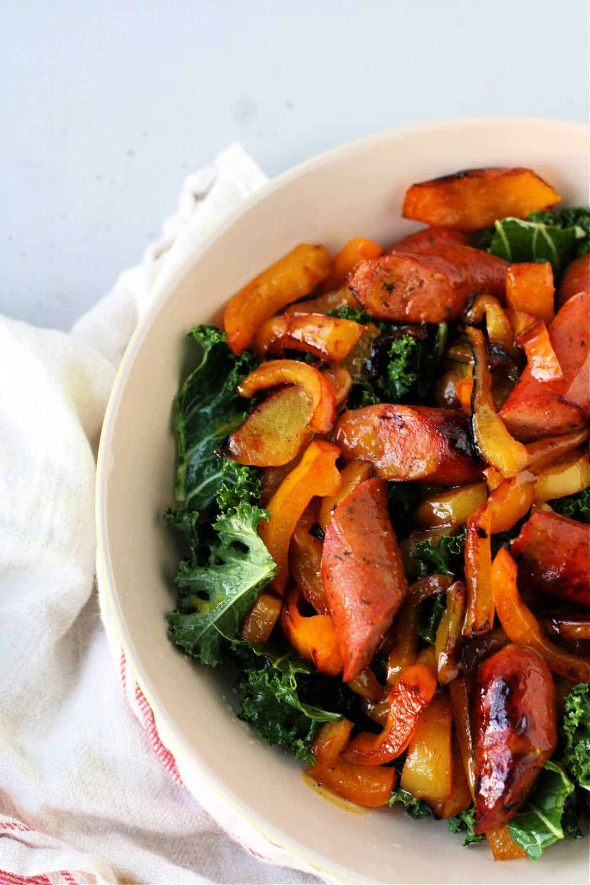 sausages and peppers over curly kale