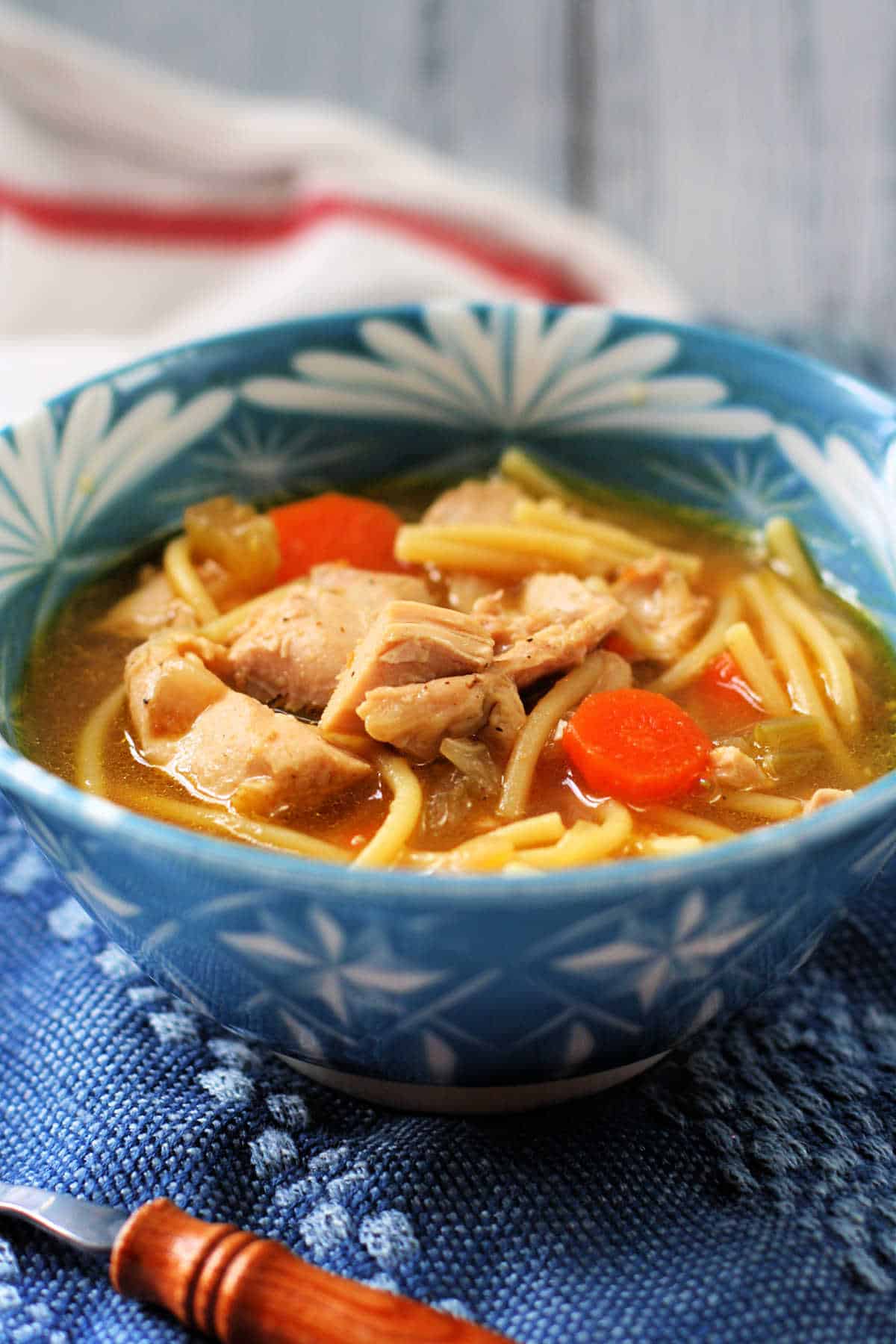 gluten free chicken noodle soup in a blue and white bowl