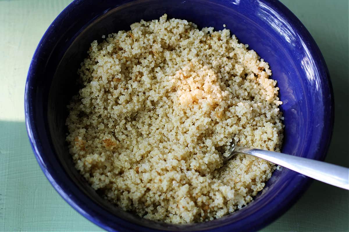 cooked quinoa in a blue serving bowl