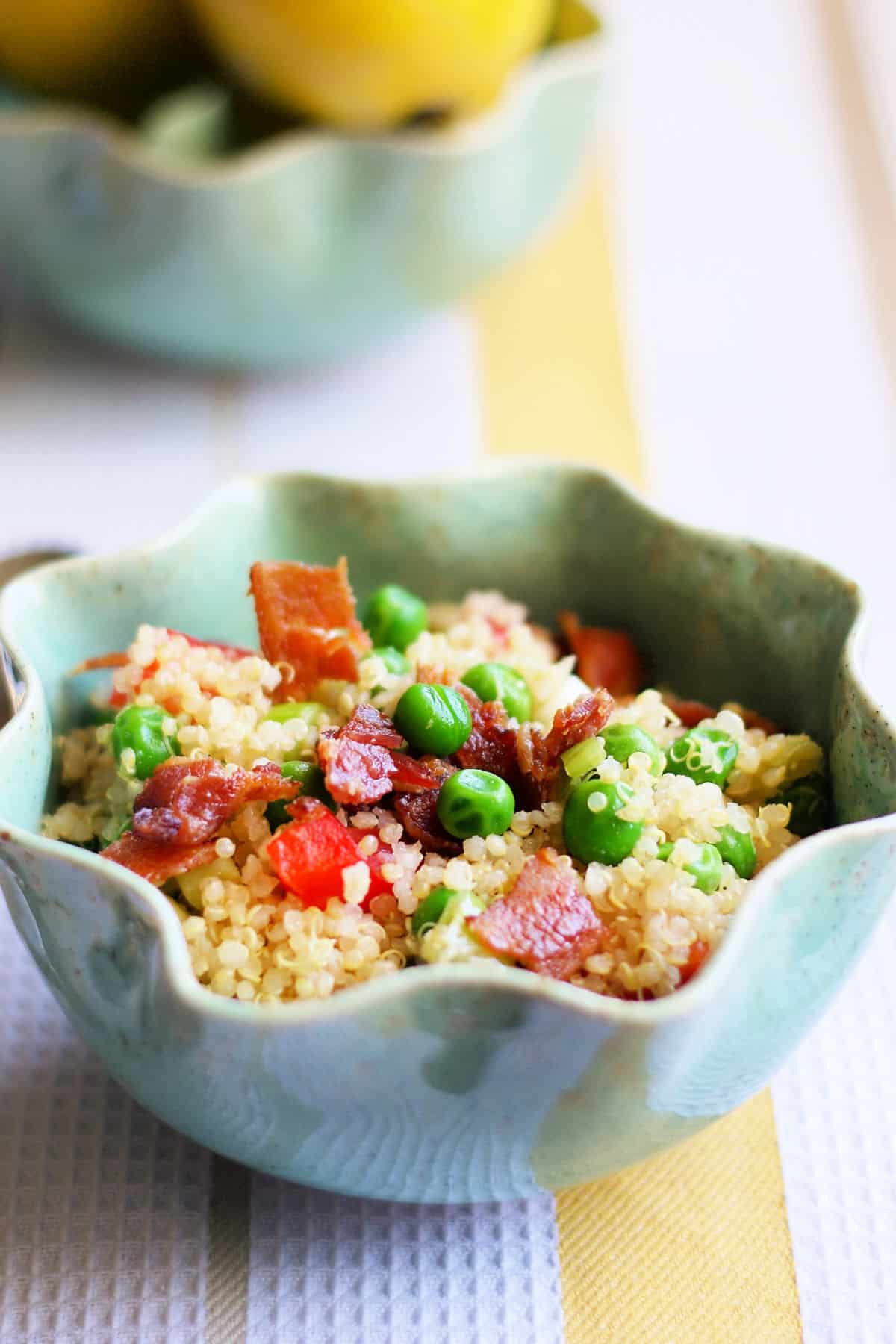 quinoa salad with peas and lemon dressing in a small aqua bowl