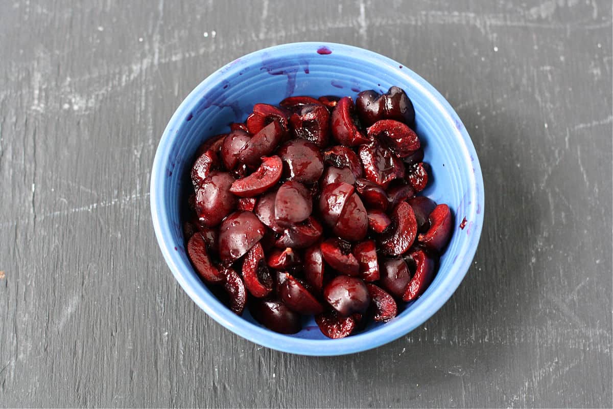 cut up fresh cherries in bowl