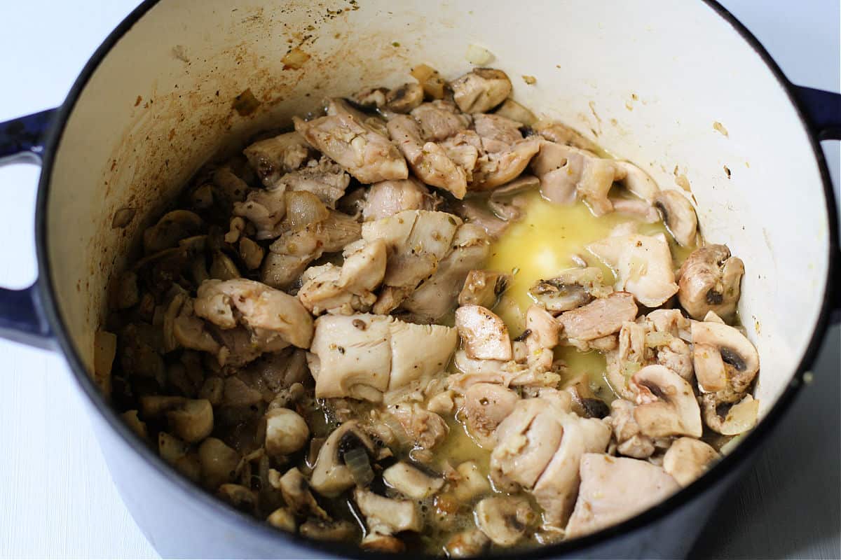 cooked chicken thighs and mushrooms in dutch oven
