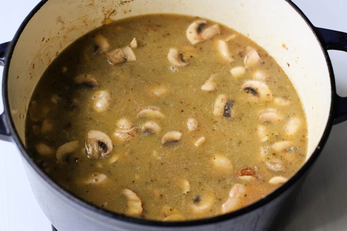 adding mushrooms rice and broth