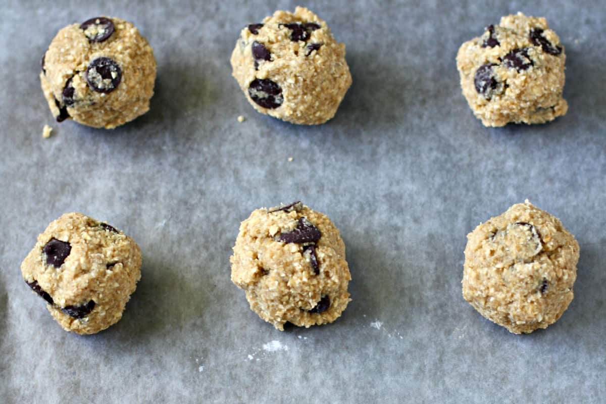 cookie dough balls on a cookie sheet