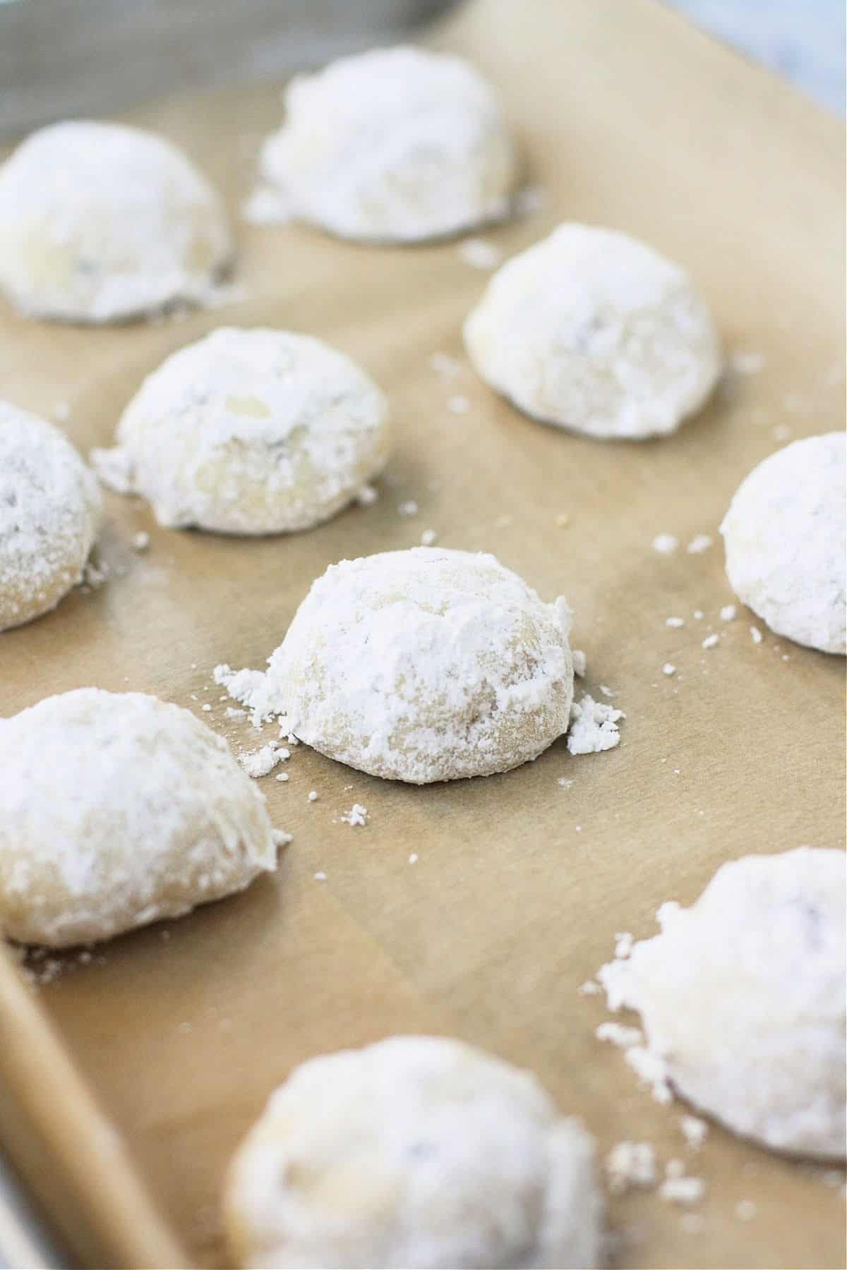 vegan snowball cookies on a cookie sheet