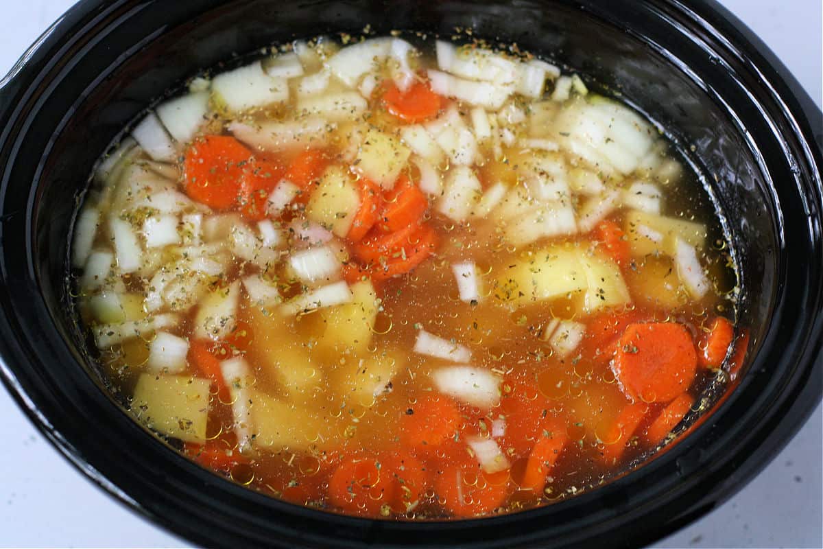 adding the broth to the slow cooker