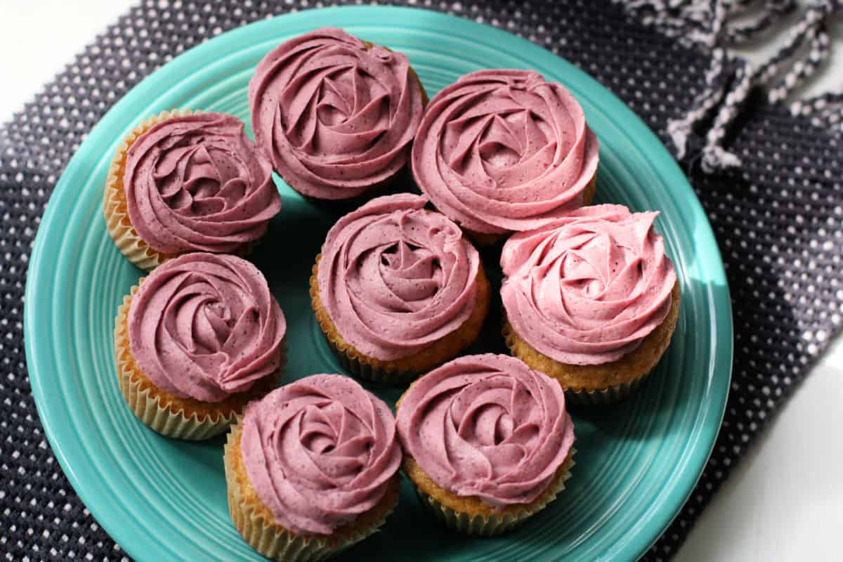 plate of blueberry frosted cupcakes