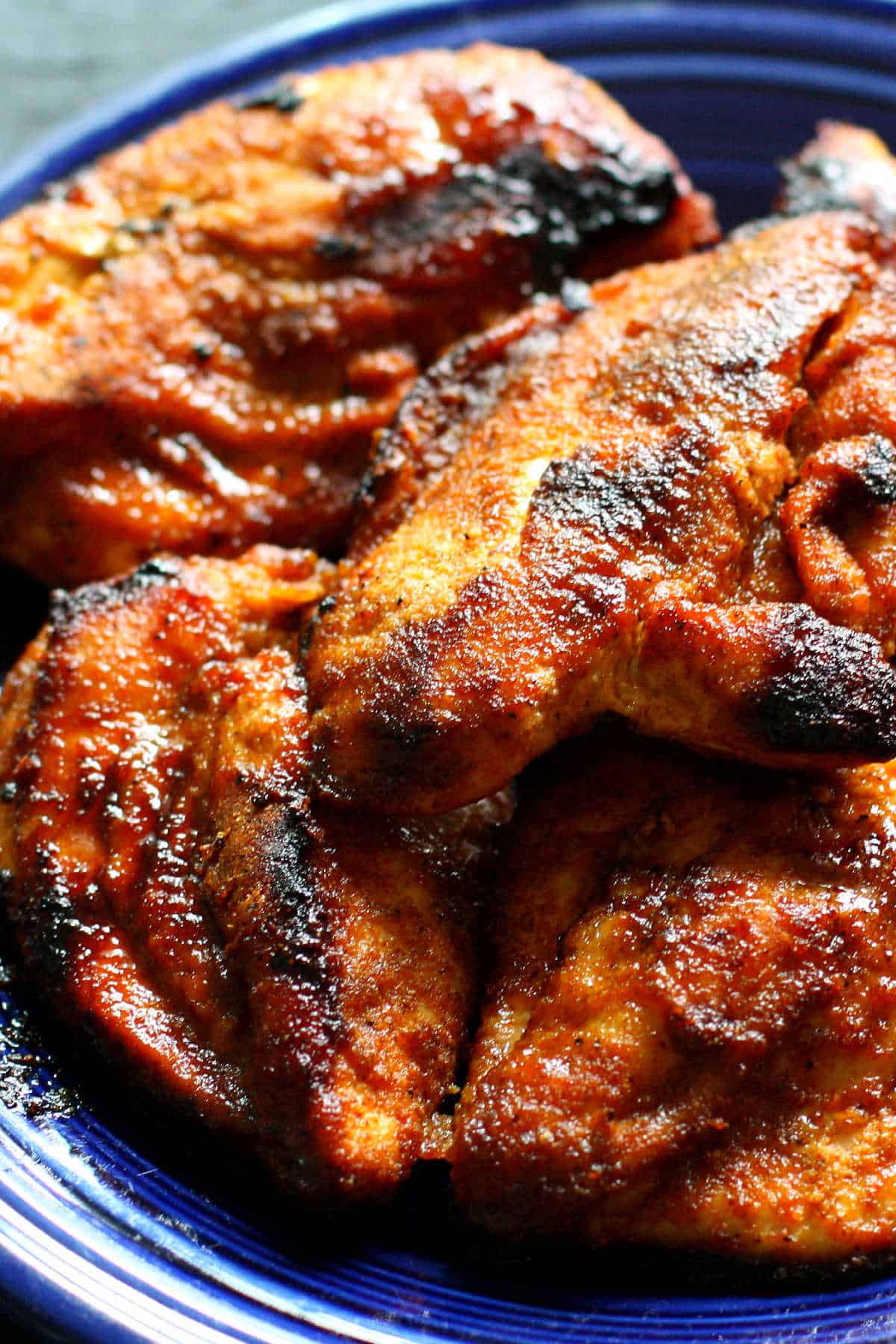barbecue chicken with spice rub on a blue plate